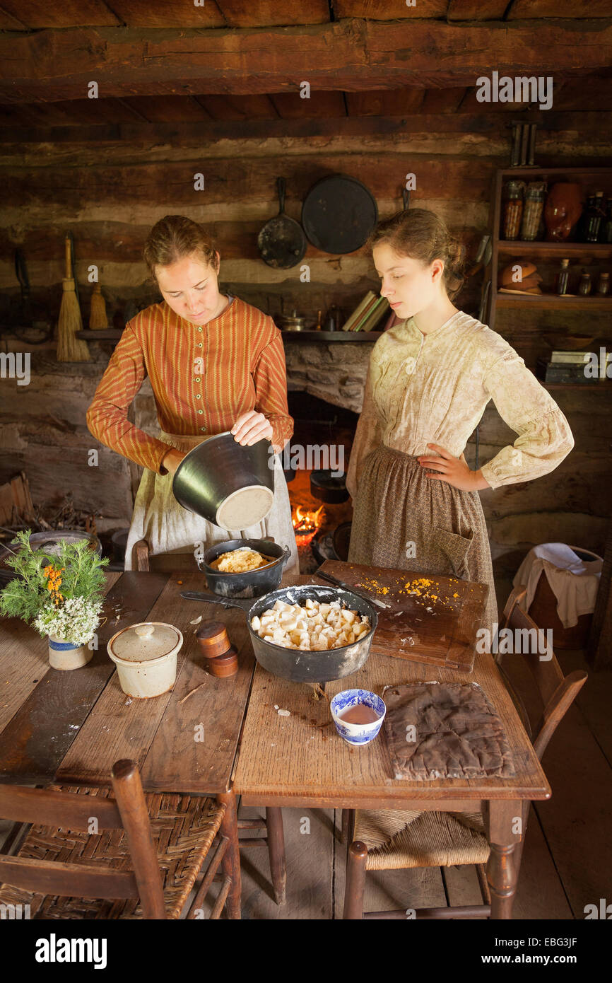 Pioneer cooking in dutch ovens. Stock Photo