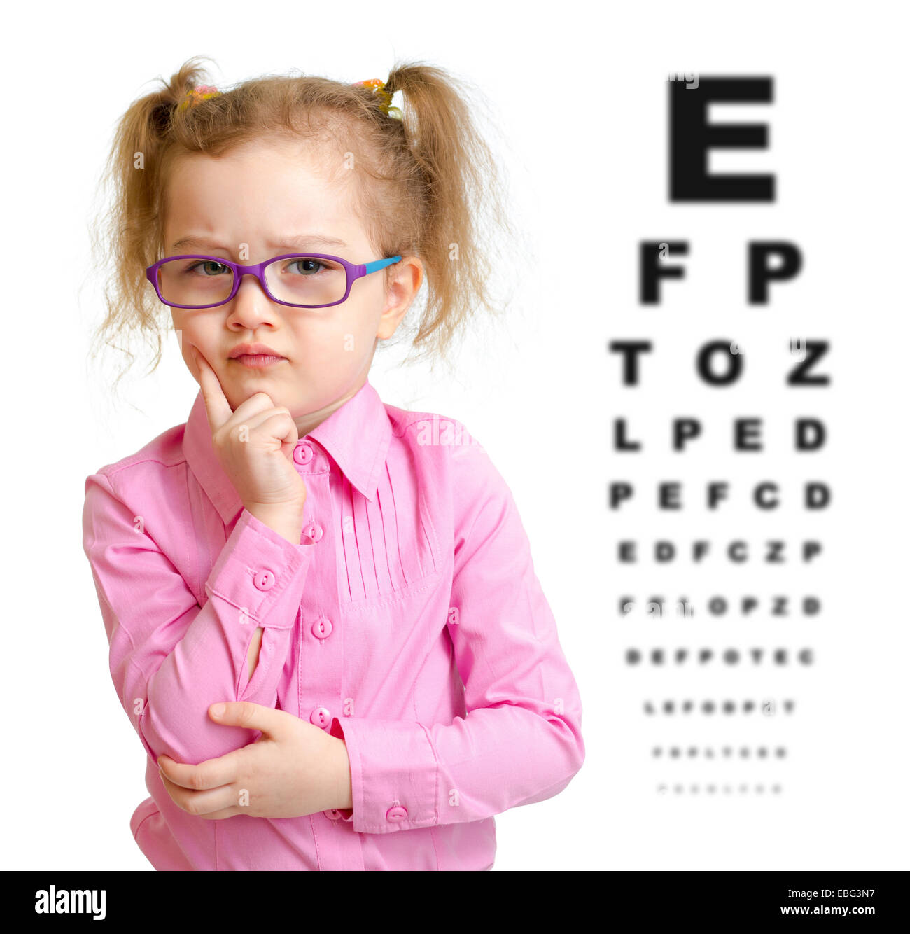 Serious girl in glasses with eye chart isolated Stock Photo