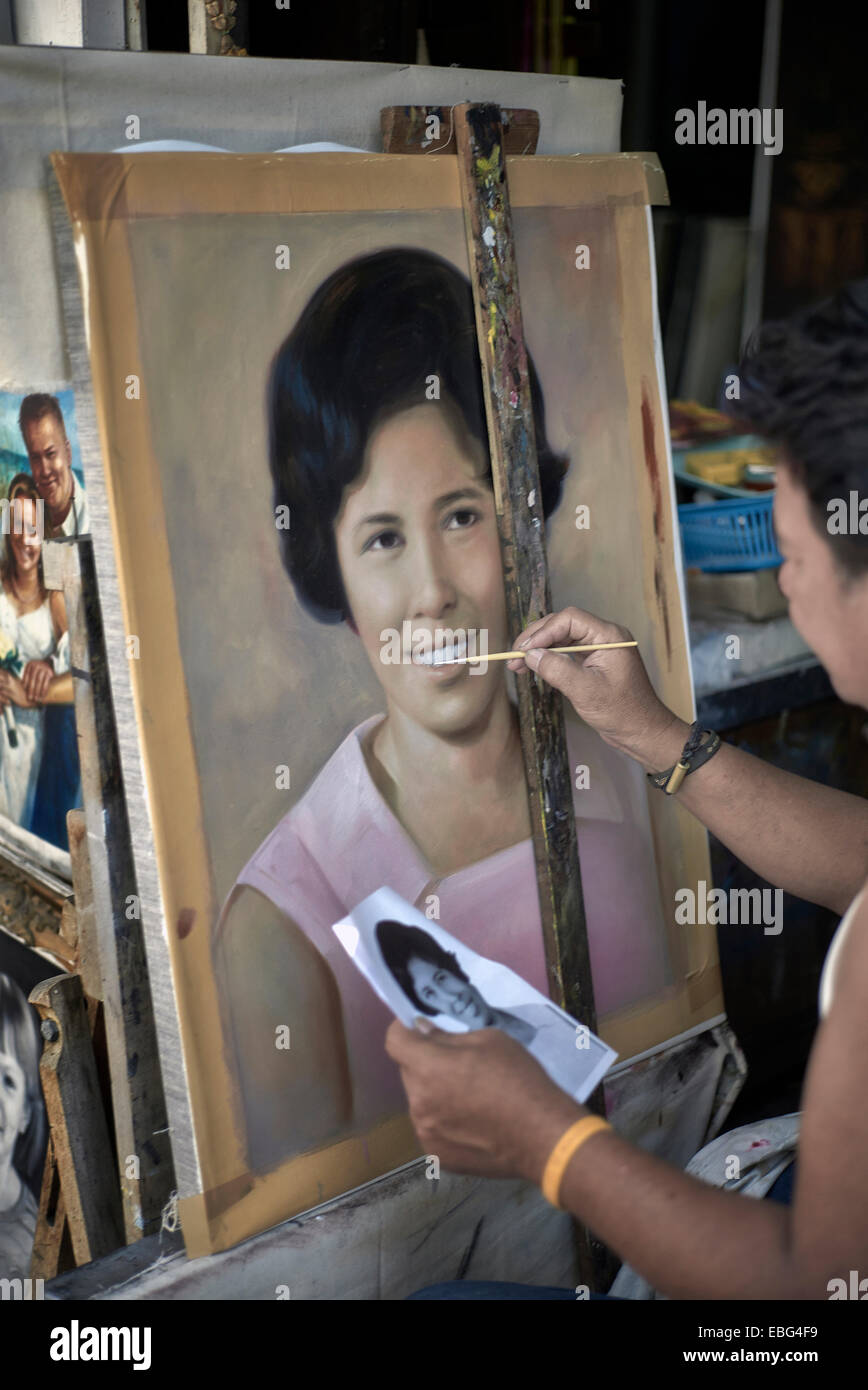 Artist painting a female portrait from a photograph Stock Photo - Alamy