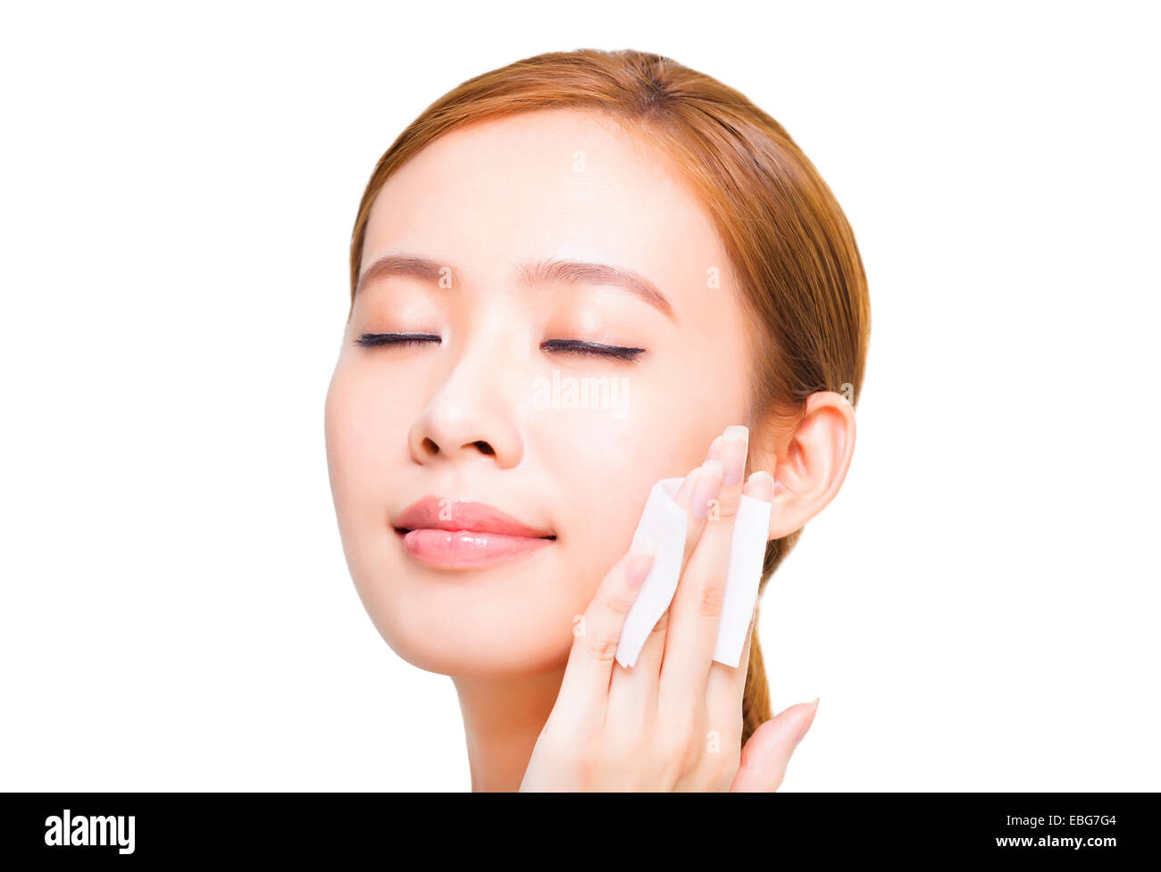 Beautiful young woman cleaning her face with cotton Stock Photo - Alamy