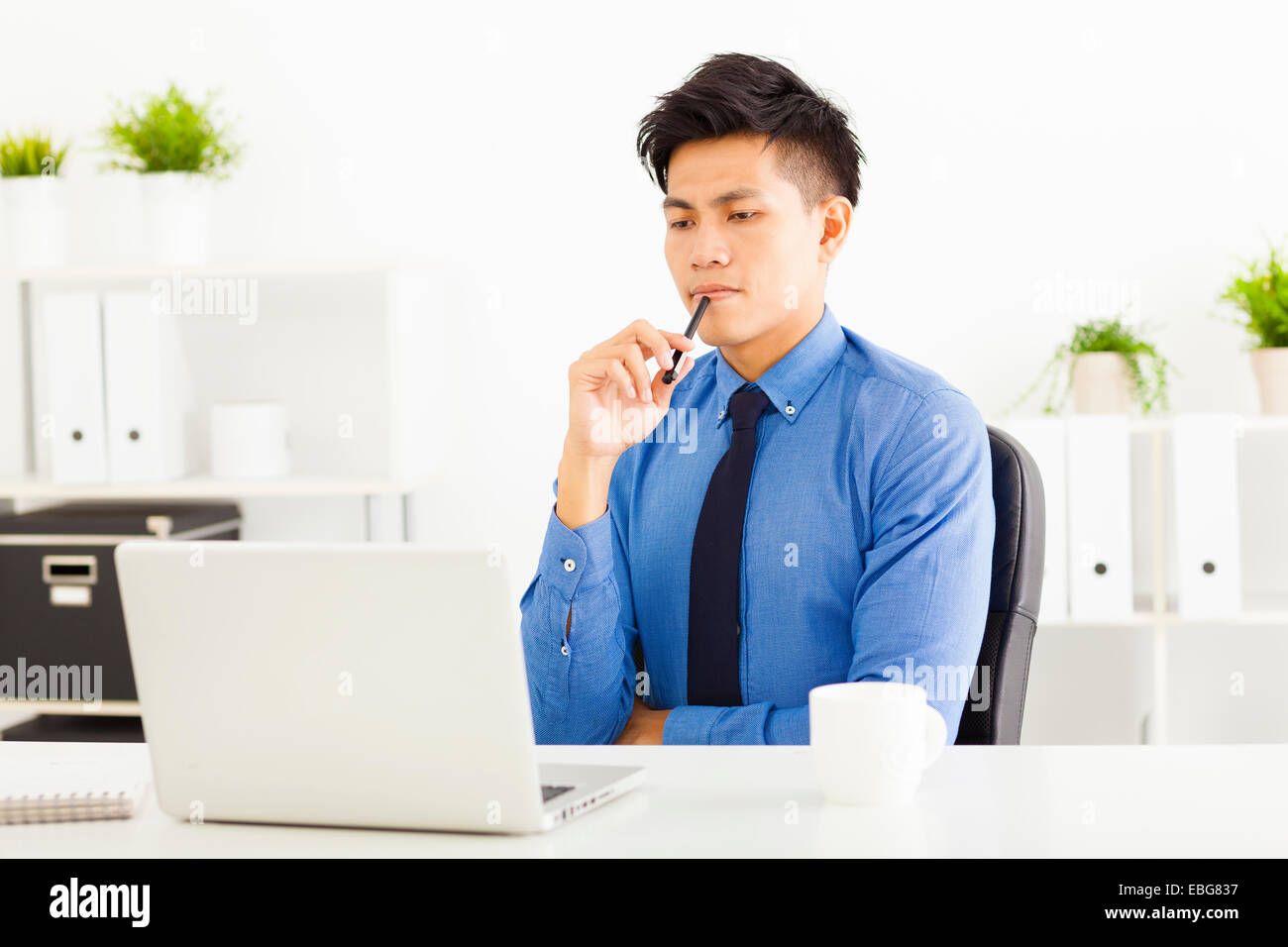 Young business man watching laptop and planning Stock Photo
