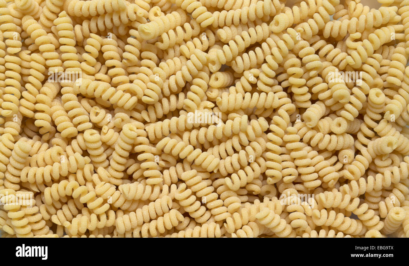 full frame italian pasta background with lots of Fusilli noodles Stock Photo