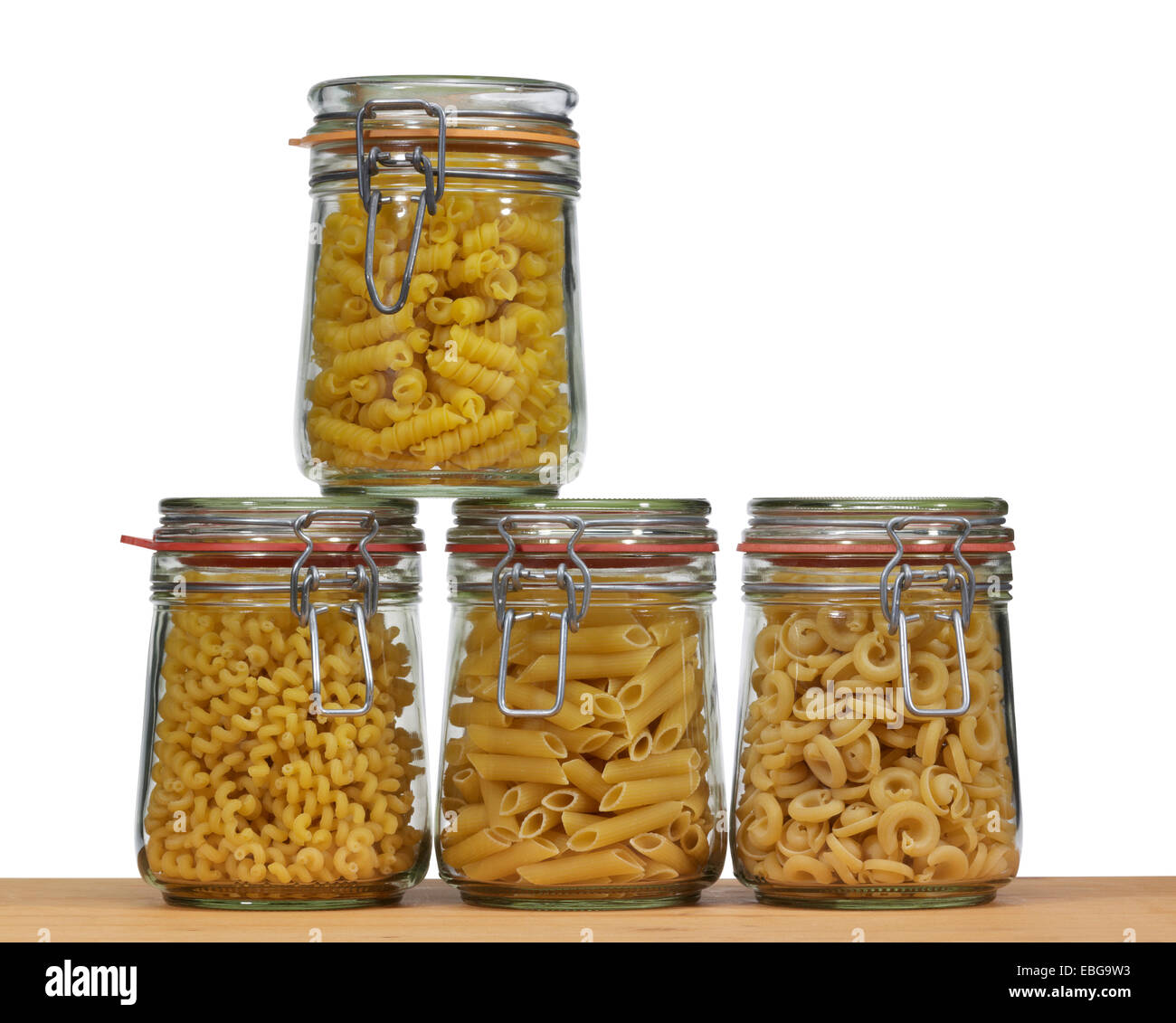 wooden board and some preserving bottles made of glass filled with