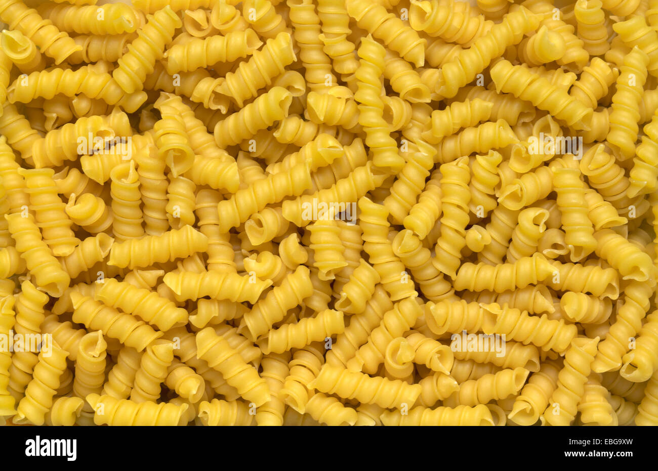 full frame italian pasta background with lots of Torchietti noodles Stock Photo