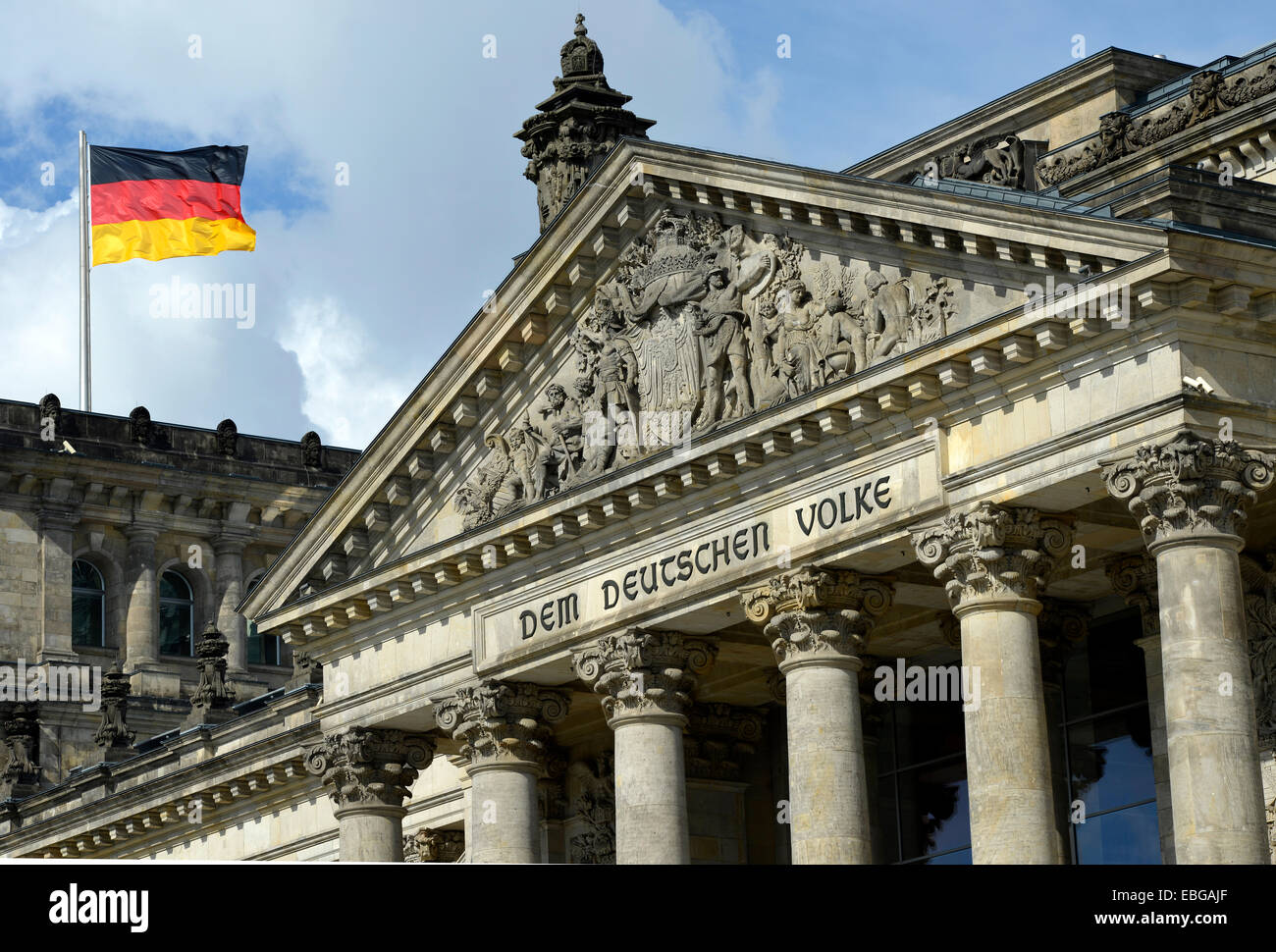 German flag flying on the Reichstag building, parliament, Bundestag, lettering on the tympanum above the main portal 'Dem Stock Photo