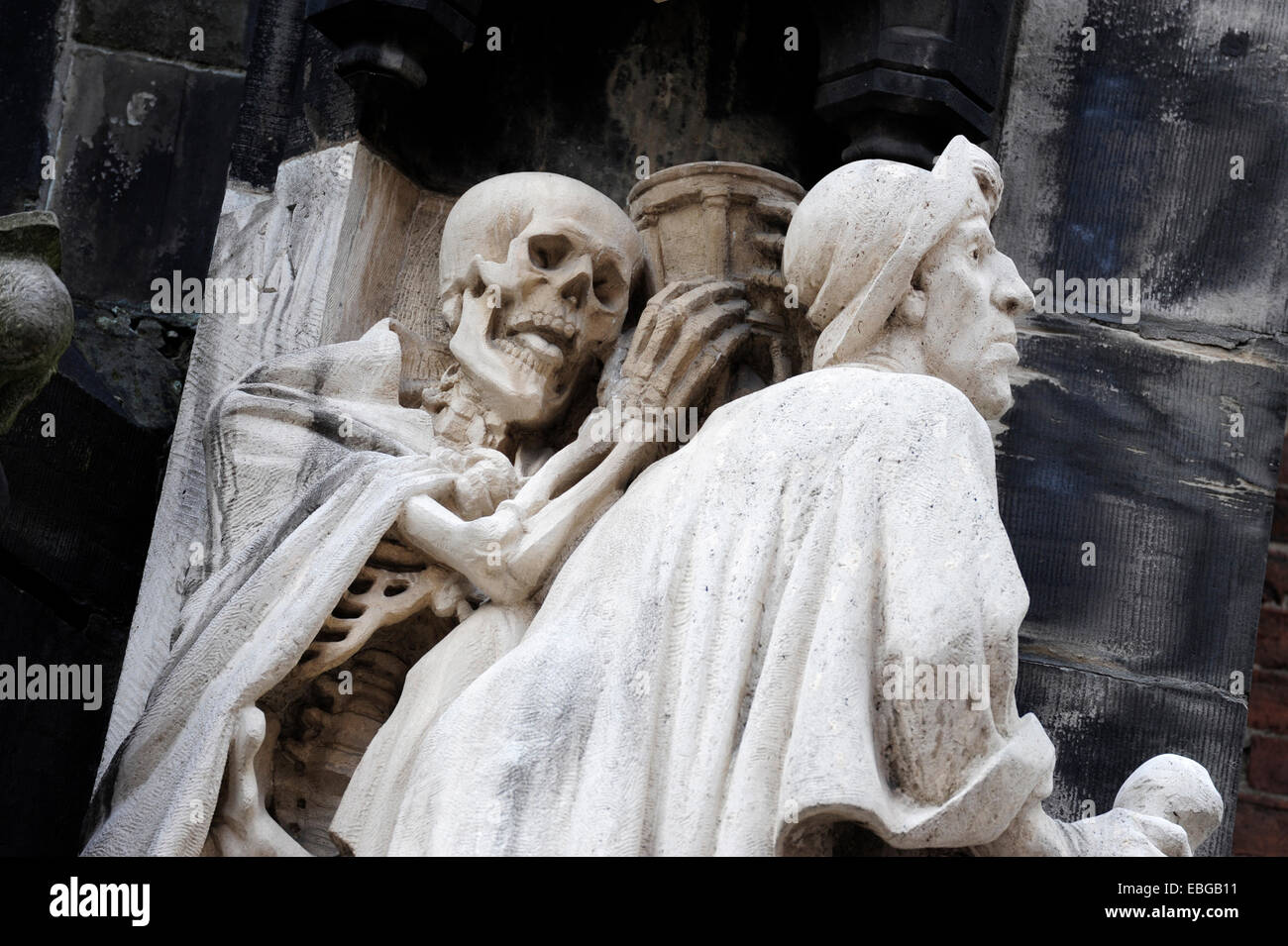 Skeleton, death, behind St. James, Memento Mori motif at the entrance of the Market Church of Sts. George and James Stock Photo