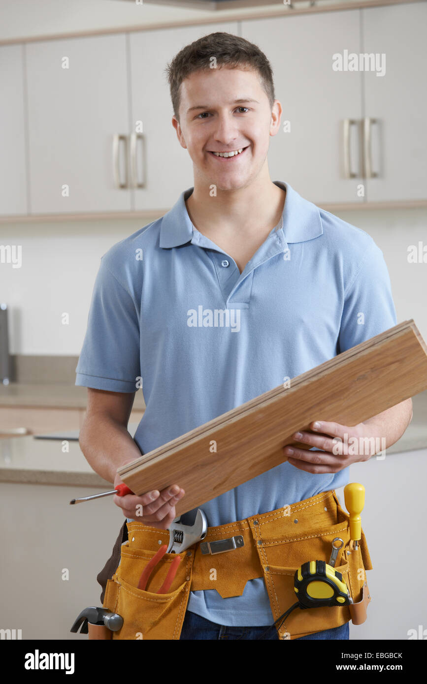 Portrait Of Carpenter Installing Fitted Kitchen Stock Photo