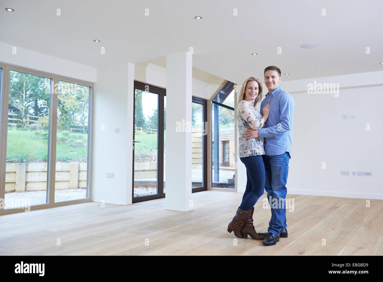 Portrait Of Happy Young Couple In New Home Stock Photo - Alamy