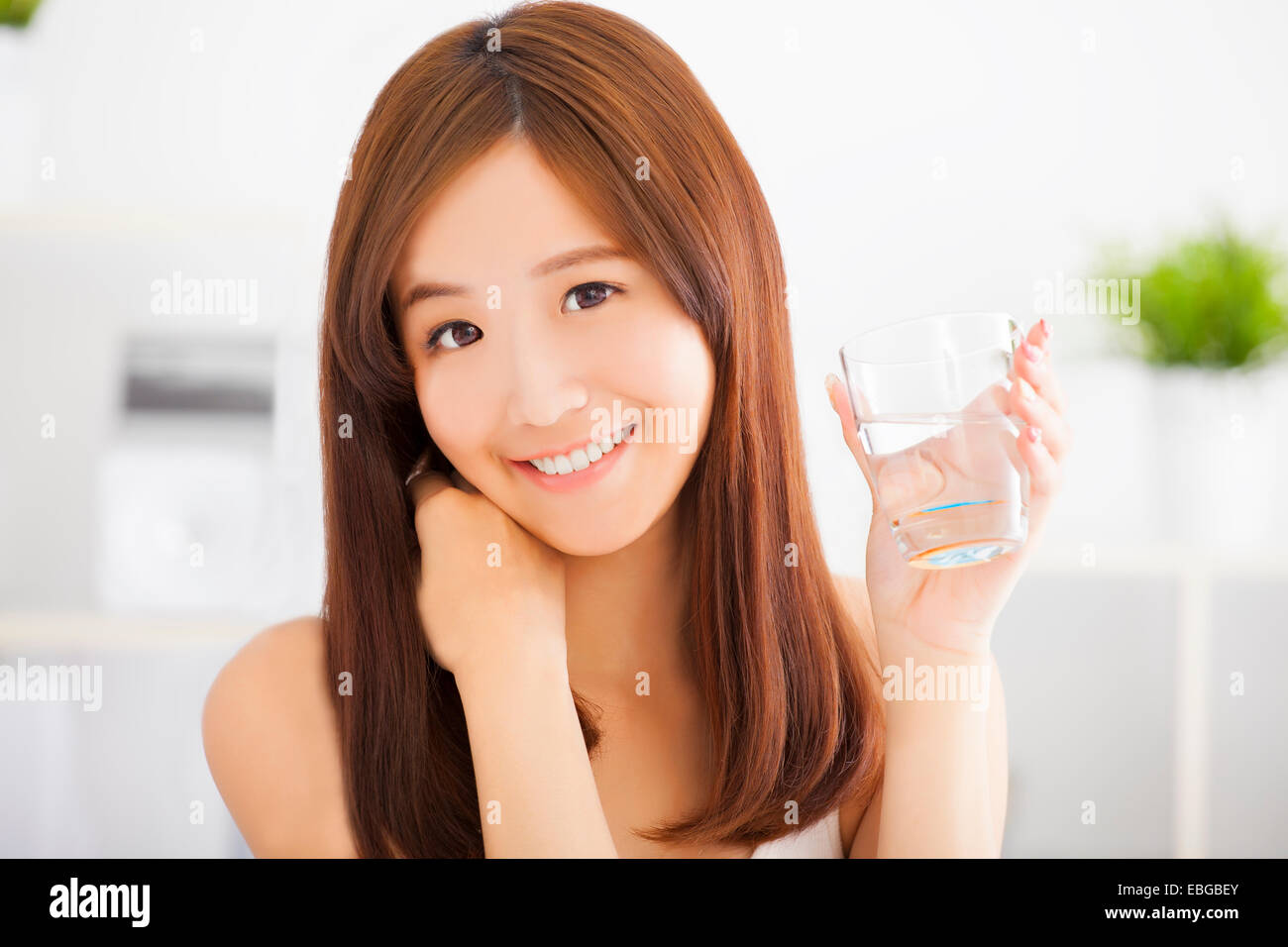 Young attractive woman drinking clean water Stock Photo