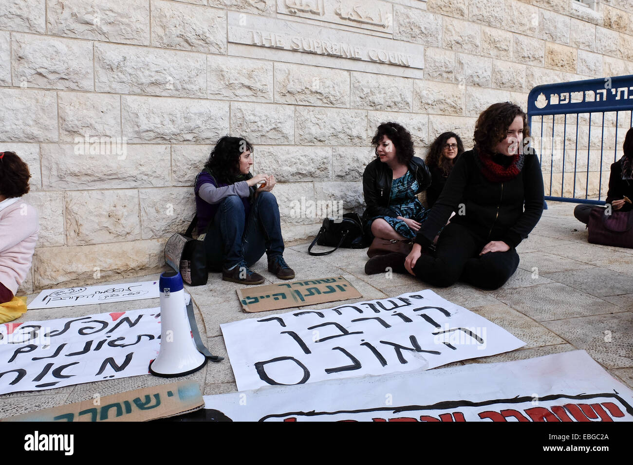 Jerusalem. 1st December, 2014. Supporters, denied access into an already packed beyond capacity court room, advocate for the release of Yonatan Hailu outside the Supreme Court, as judges consider an appeal submitted on his 20 year sentence. Hailu, 24, bearing no previous criminal record, was convicted by the Lod District Court for the 2010 murder of Yaron Eileen who had previously been tried for raping an under-age girl, property crimes, extortion and assaulting police officers. Hailu claimed self defense after being extorted and raped by Eileen. Credit:  Nir Alon/Alamy Live News Stock Photo