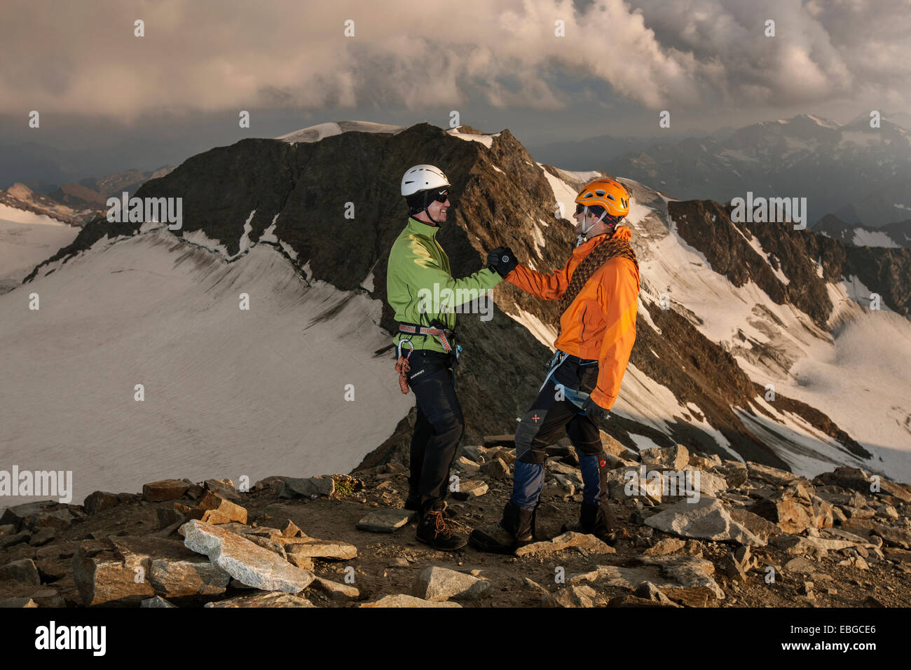 Mountain climbers congratulating one another following the ascent to the summit of Wilder Pfaff Mountain, Stubai Valley Stock Photo