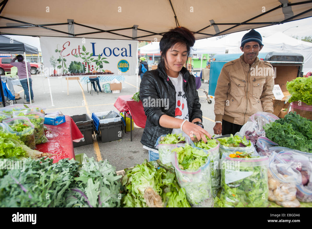 Woman selling vegetables at a farmers market Stock Photo