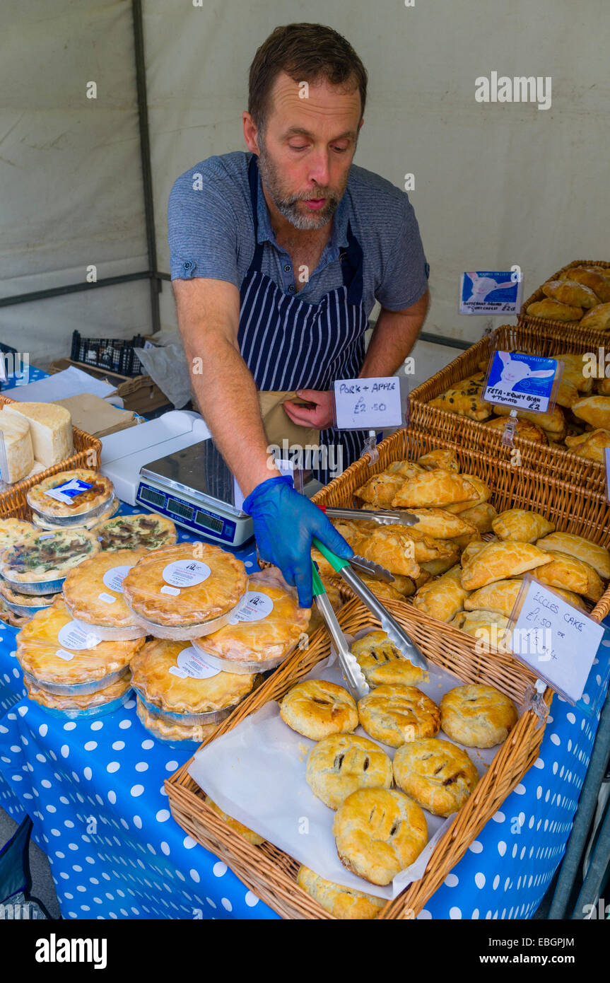 A man selling locally made cakes and pies at Aberystwyth food farmers ...