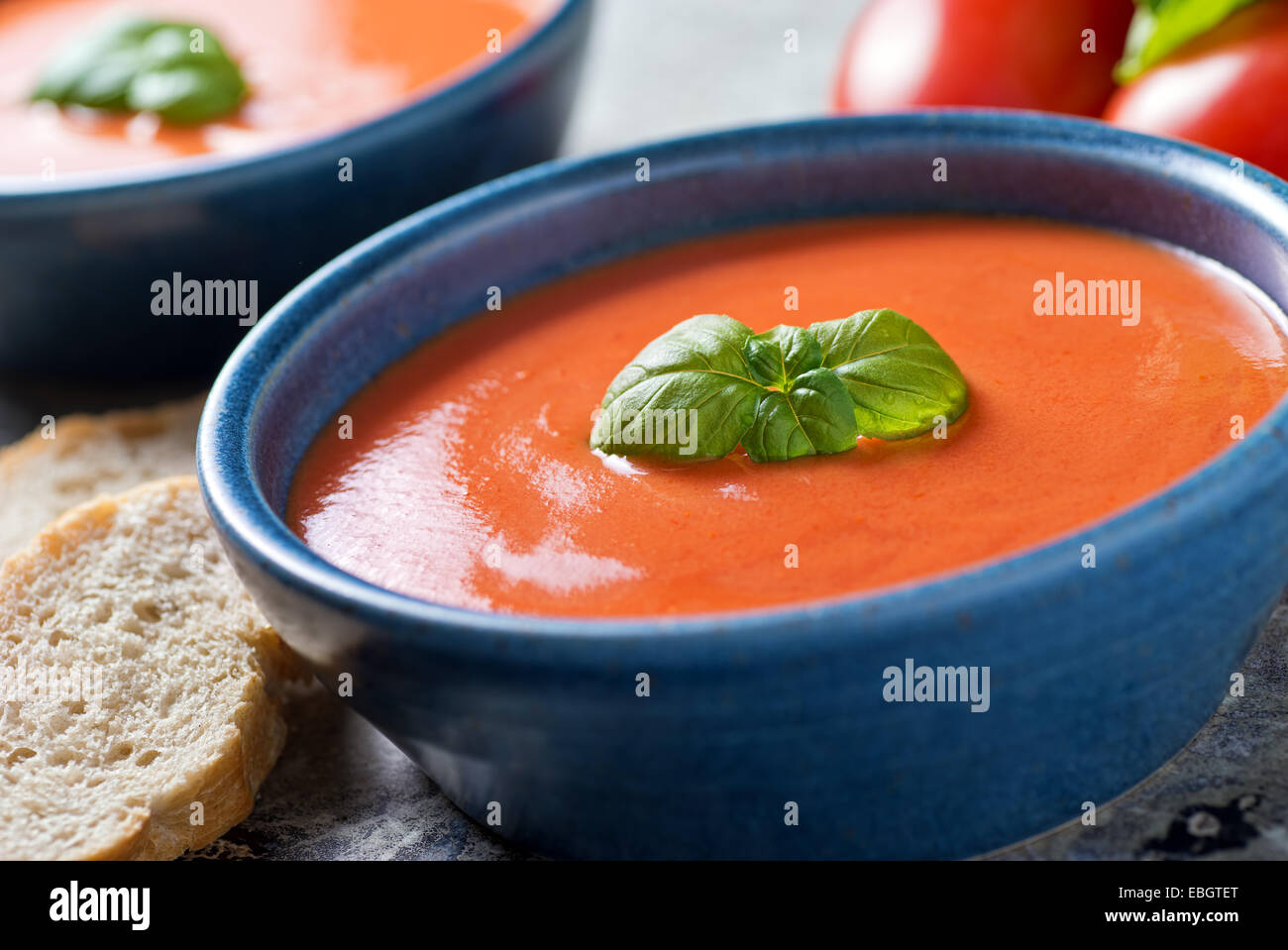 A bowl of delicious home made tomato basil soup. Stock Photo