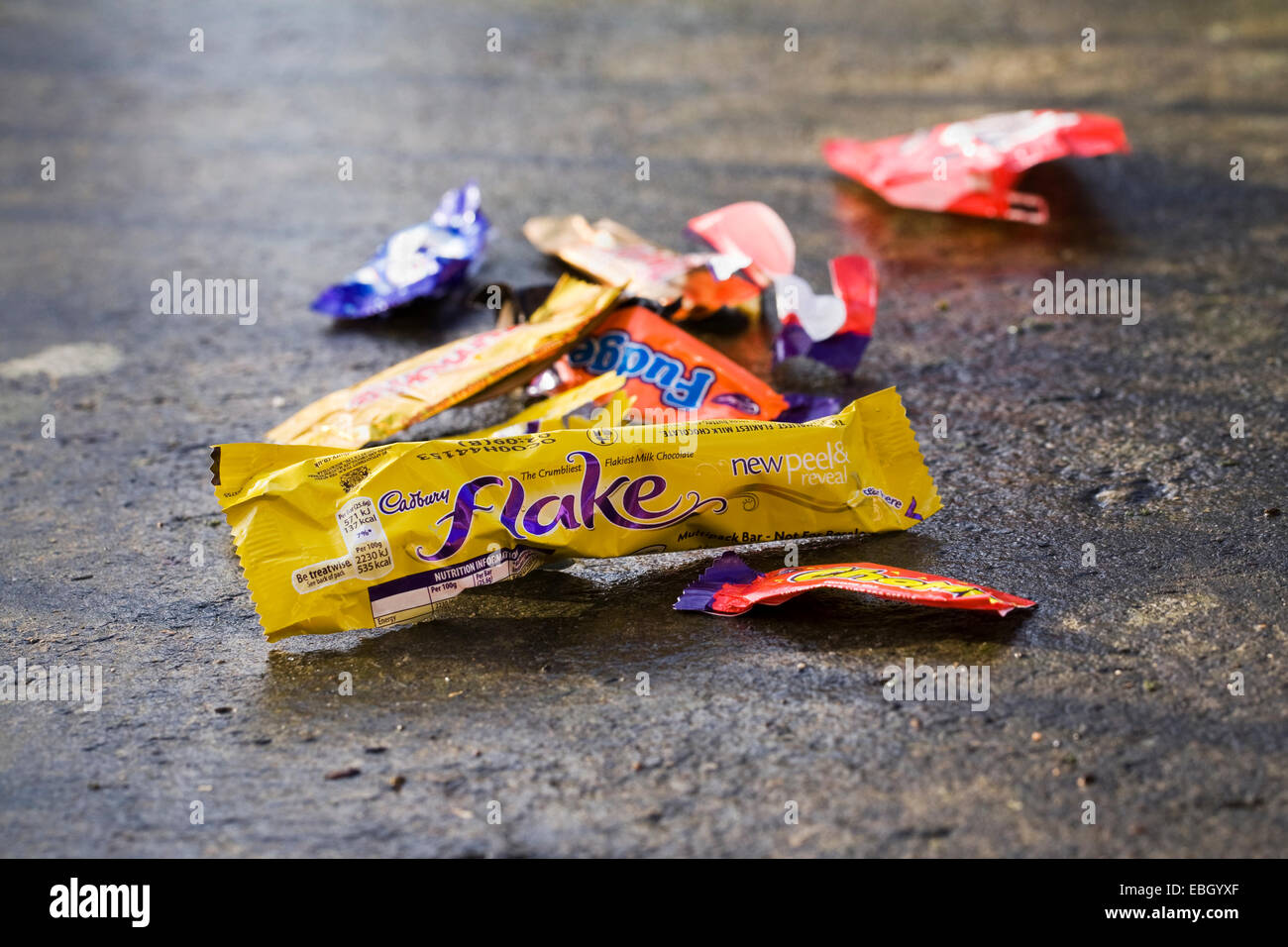 Empty sweet wrappers littering the pathway. Stock Photo