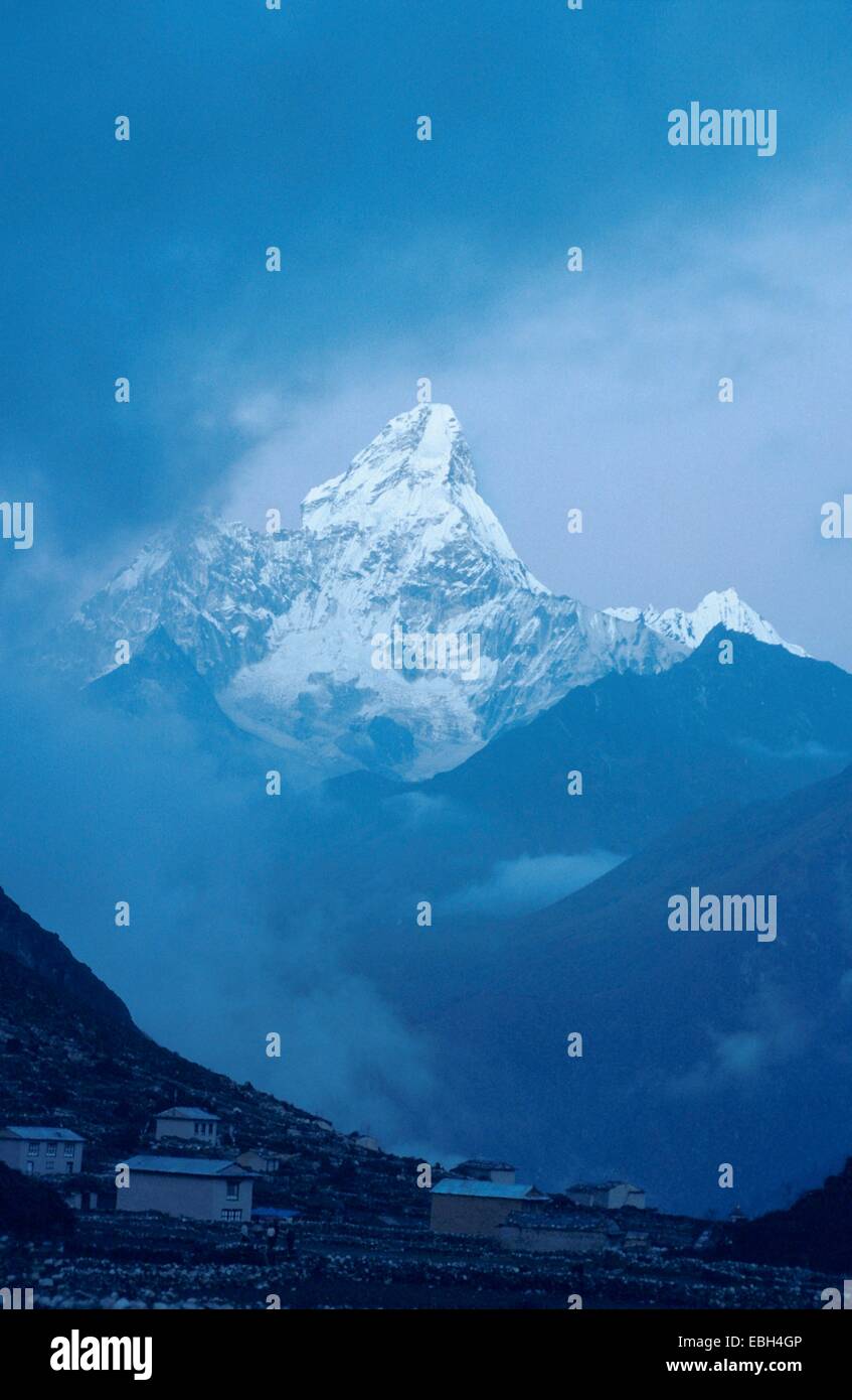 Ama Dablam (22493 ft), the sacred mountain in fog, Nepal, Khumbu Valley. Stock Photo