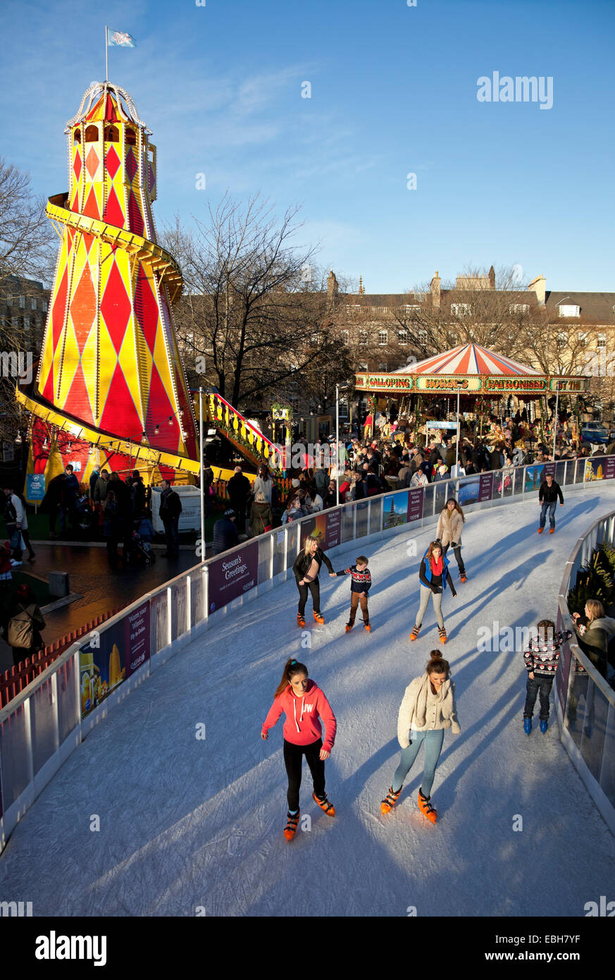 Ice Rink with fun fair rides in background St Andrew Square, Edinburgh