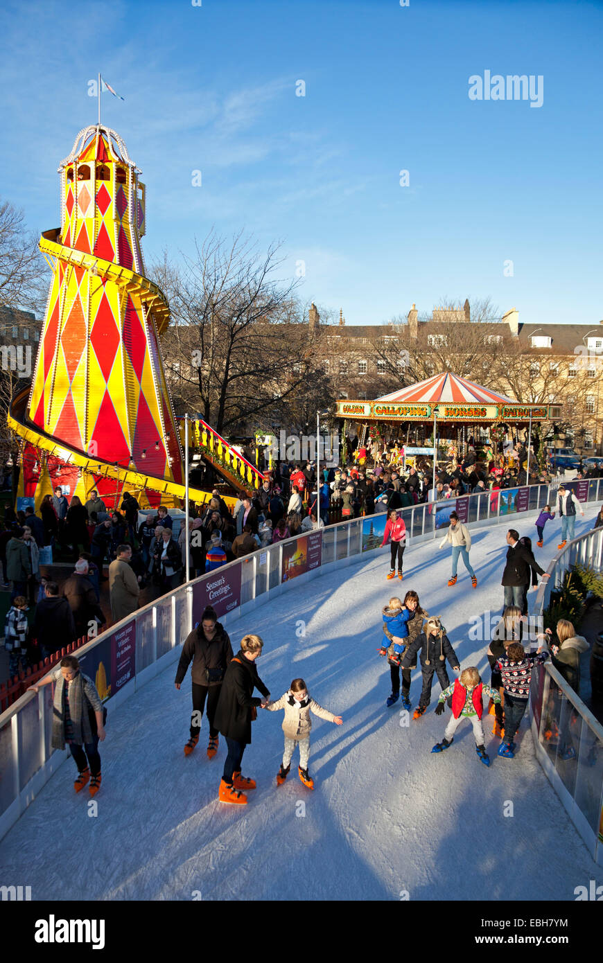 Ice Rink with fun fair rides in background St Andrew Square, Edinburgh Scotland UK Stock Photo