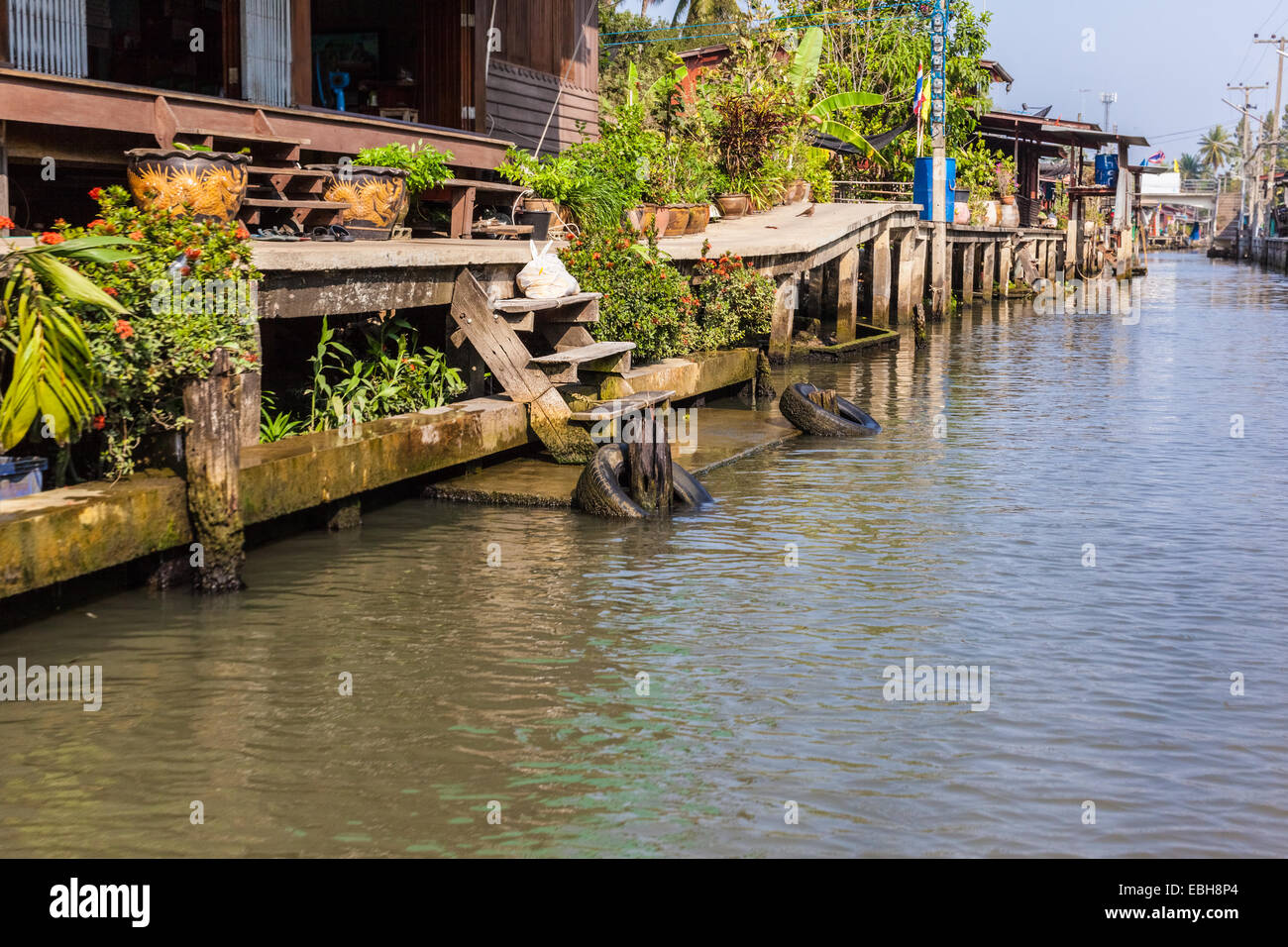 hovels of a small village on the riverside of a canal in the thai countryside in Ratchaburi district, Thailand Stock Photo