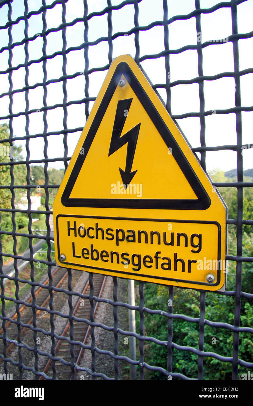 warning sign 'high voltage' and protective lattice, Germany Stock Photo
