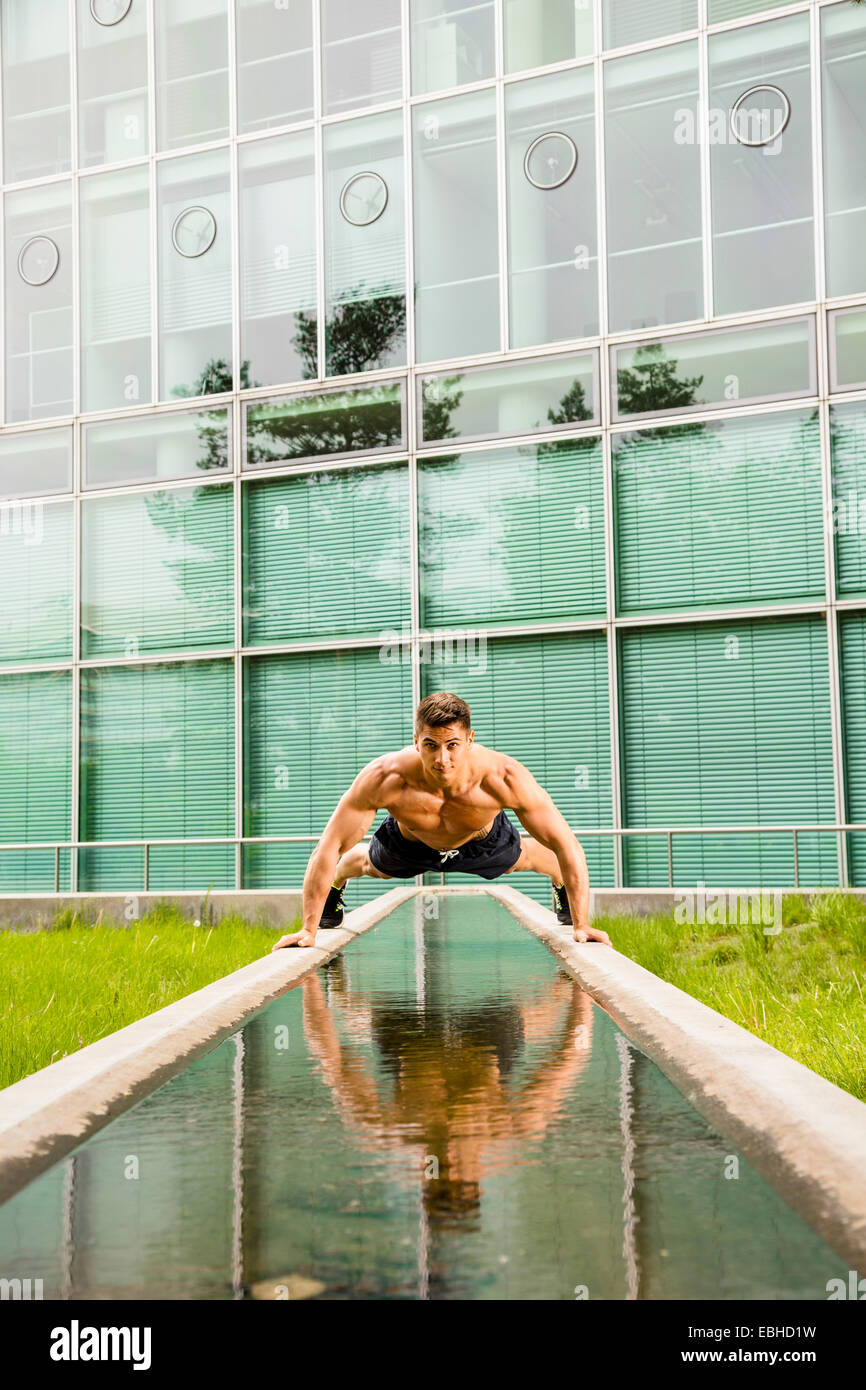 Personal trainer doing outdoor training in urban place, Munich, Bavaria, Germany Stock Photo