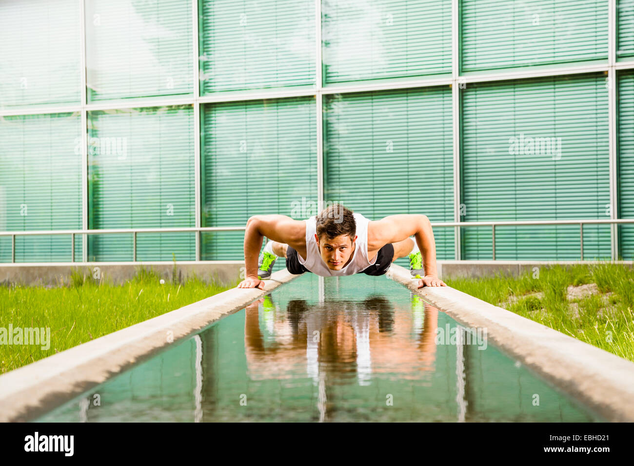 Personal trainer doing outdoor training in urban place, Munich, Bavaria, Germany Stock Photo