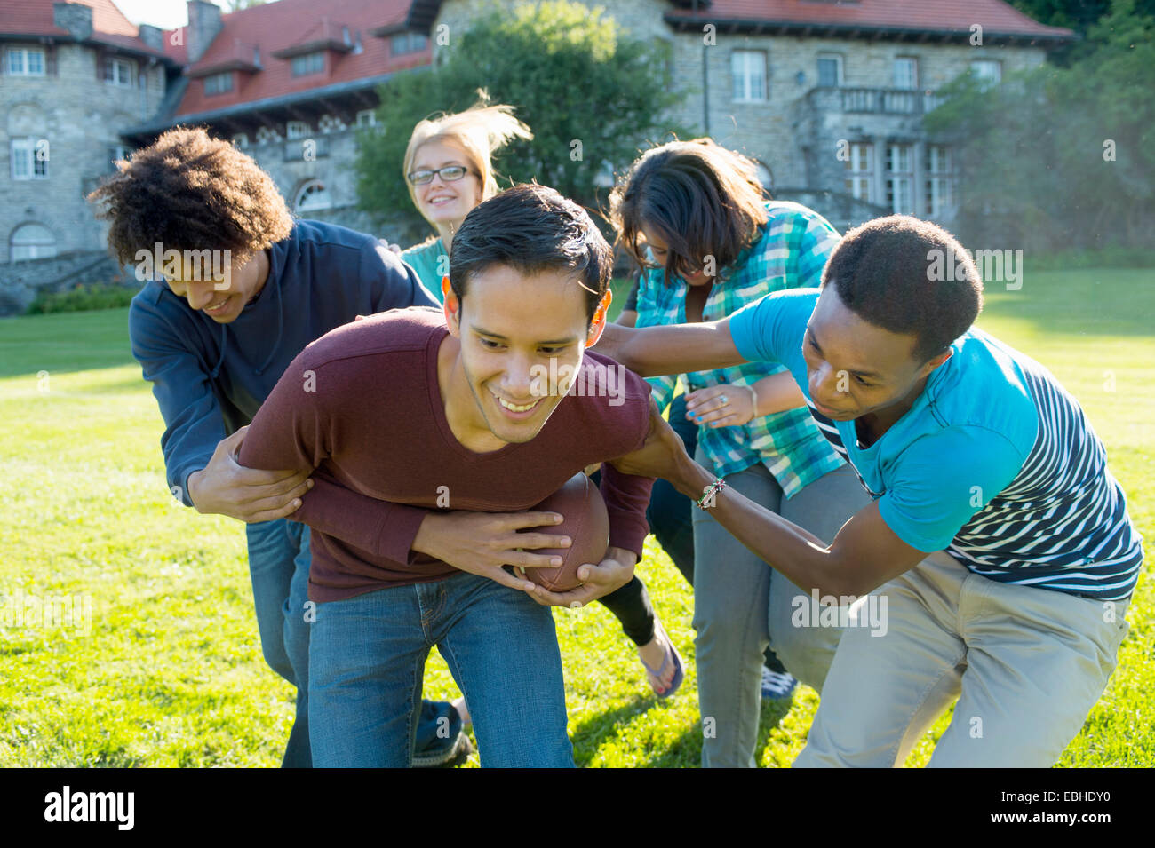 Students playing American football Stock Photo