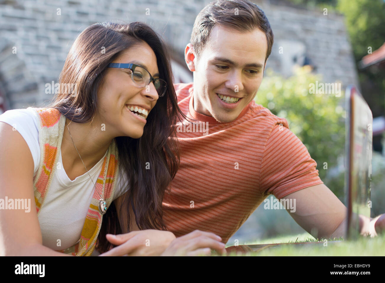 Young couple using laptop Stock Photo - Alamy