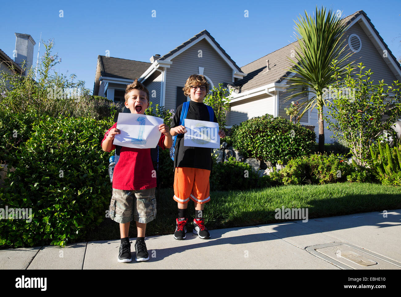 Portrait of two brothers holding up pieces of paper with 1 & 3 Stock Photo