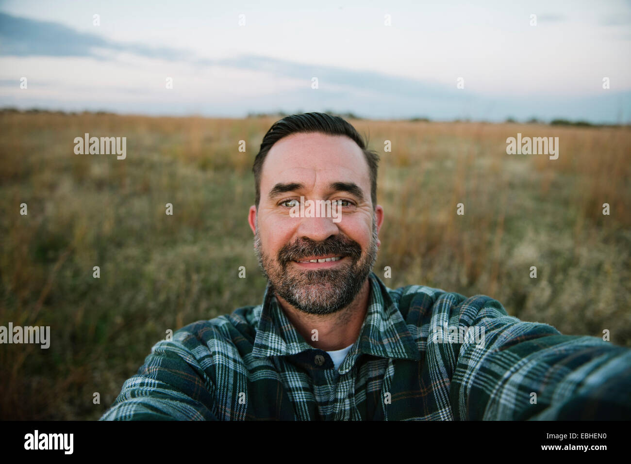 Self portrait of smiling farmer in field, Plattsburg, Missouri, USA Stock Photo