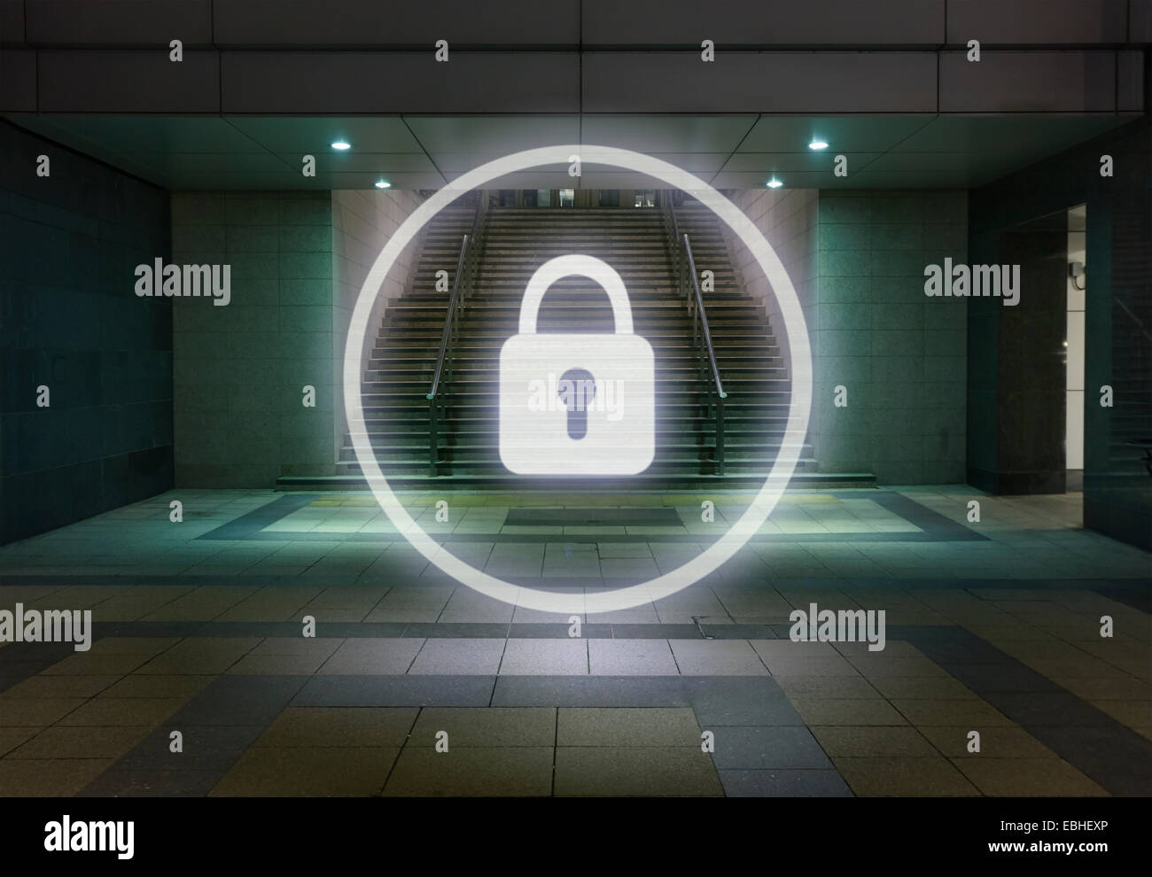 Glowing padlock symbol in office building foyer at night Stock Photo