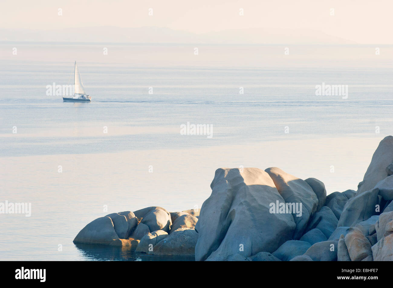 View of coastal rocks and yacht, Corsica, France Stock Photo