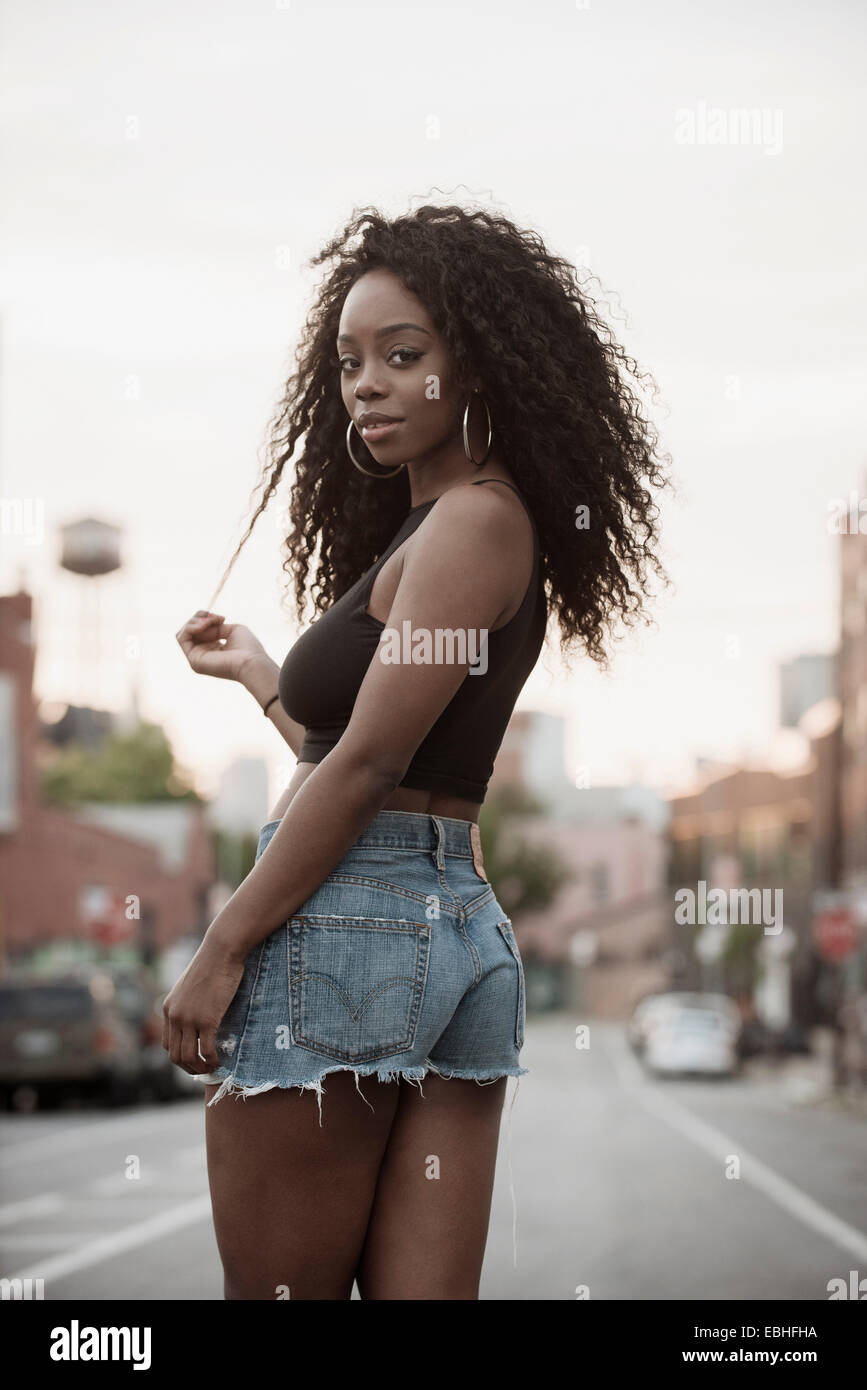 Young woman wearing hot pants looking over shoulder Stock Photo Alamy