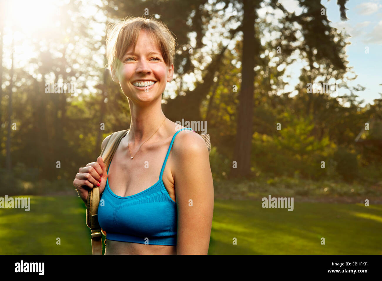 Portrait of smiling female runner in park Stock Photo