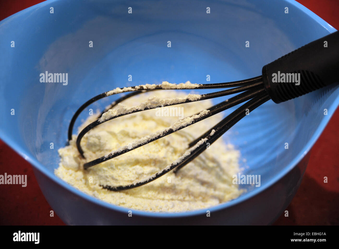 Mixing bowl with a whisk and ingredients Stock Photo Alamy