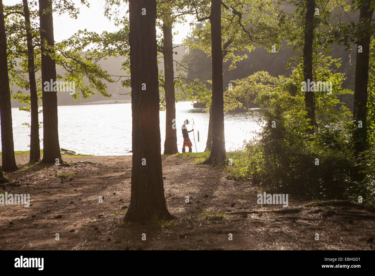 Teenage boy fishing at forest lake, Arkansas, USA Stock Photo