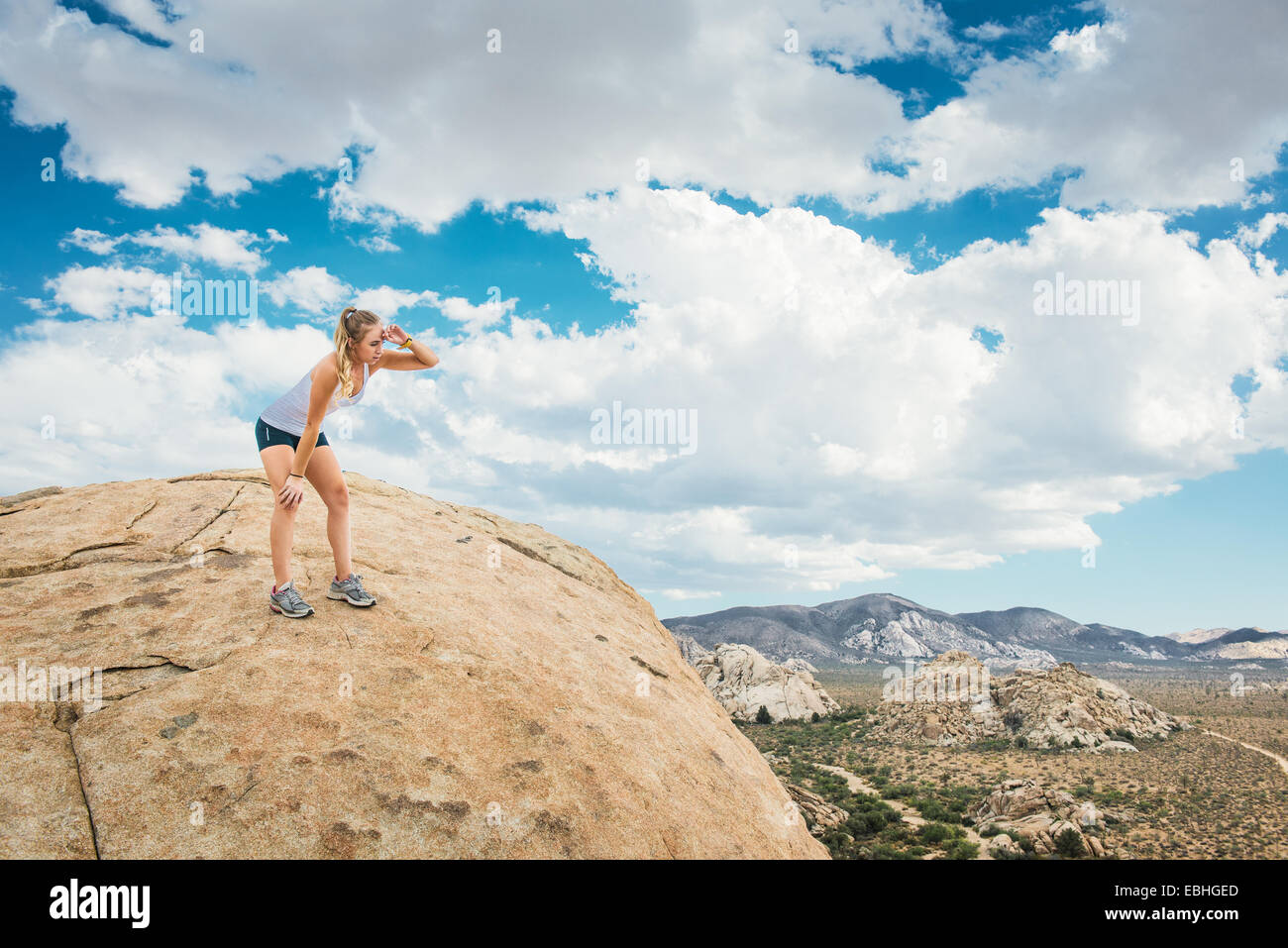 Woman taking break on mountain, Joshua Tree National Park, California, US Stock Photo