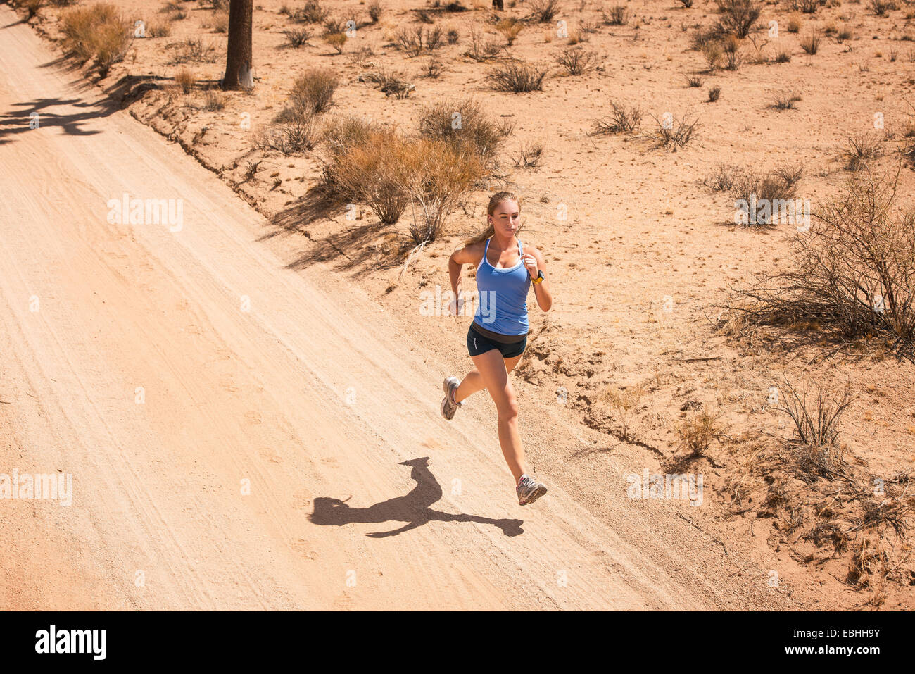 Woman running, Joshua Tree National Park, California, US Stock Photo