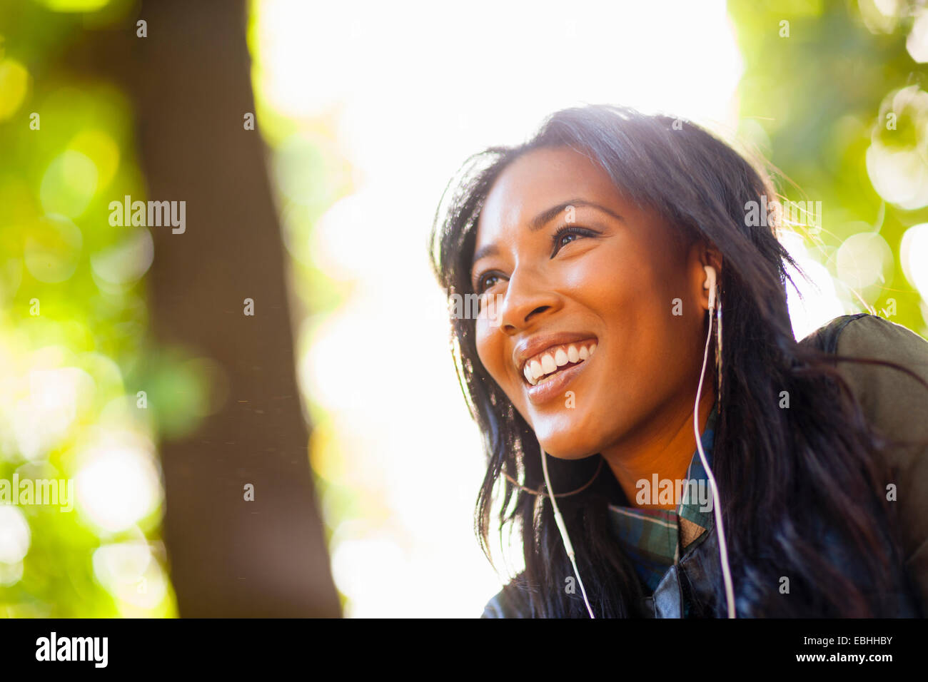 Young woman with wide smile in park Stock Photo