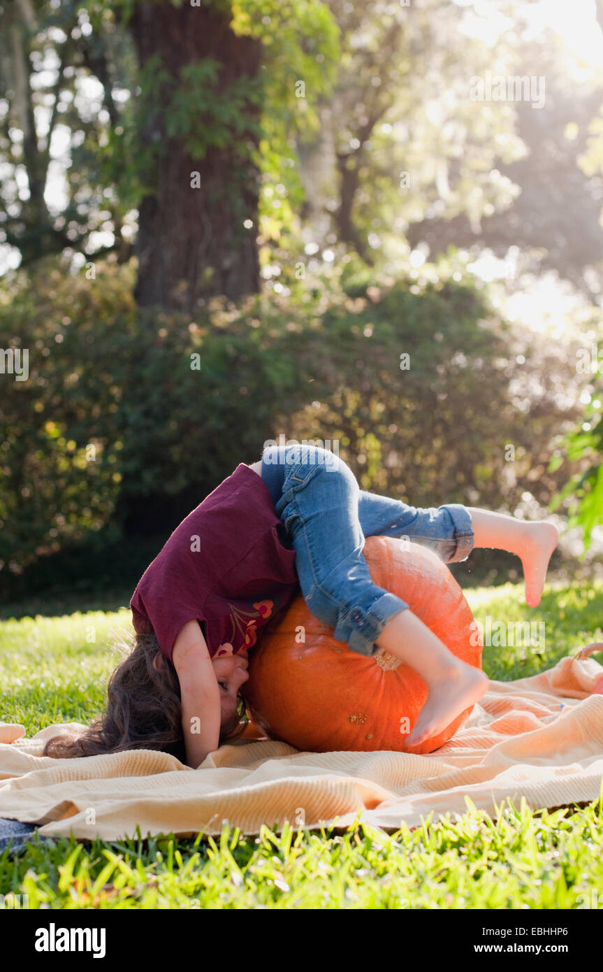 Girl lying on pumpkin Stock Photo - Alamy