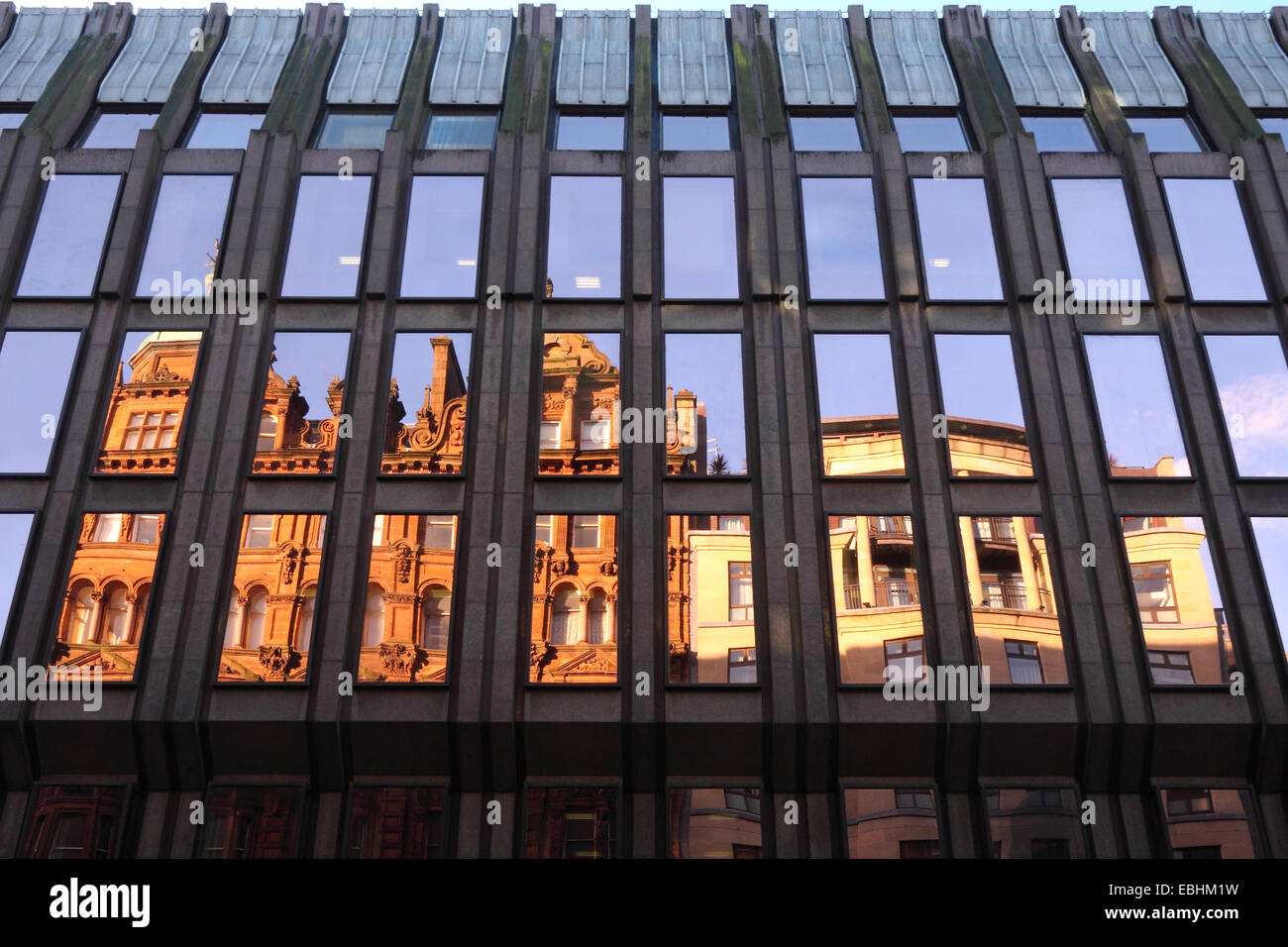 Old style buildings reflected in windows of a more modern block, West George Street, Glasgow, Scotland Stock Photo