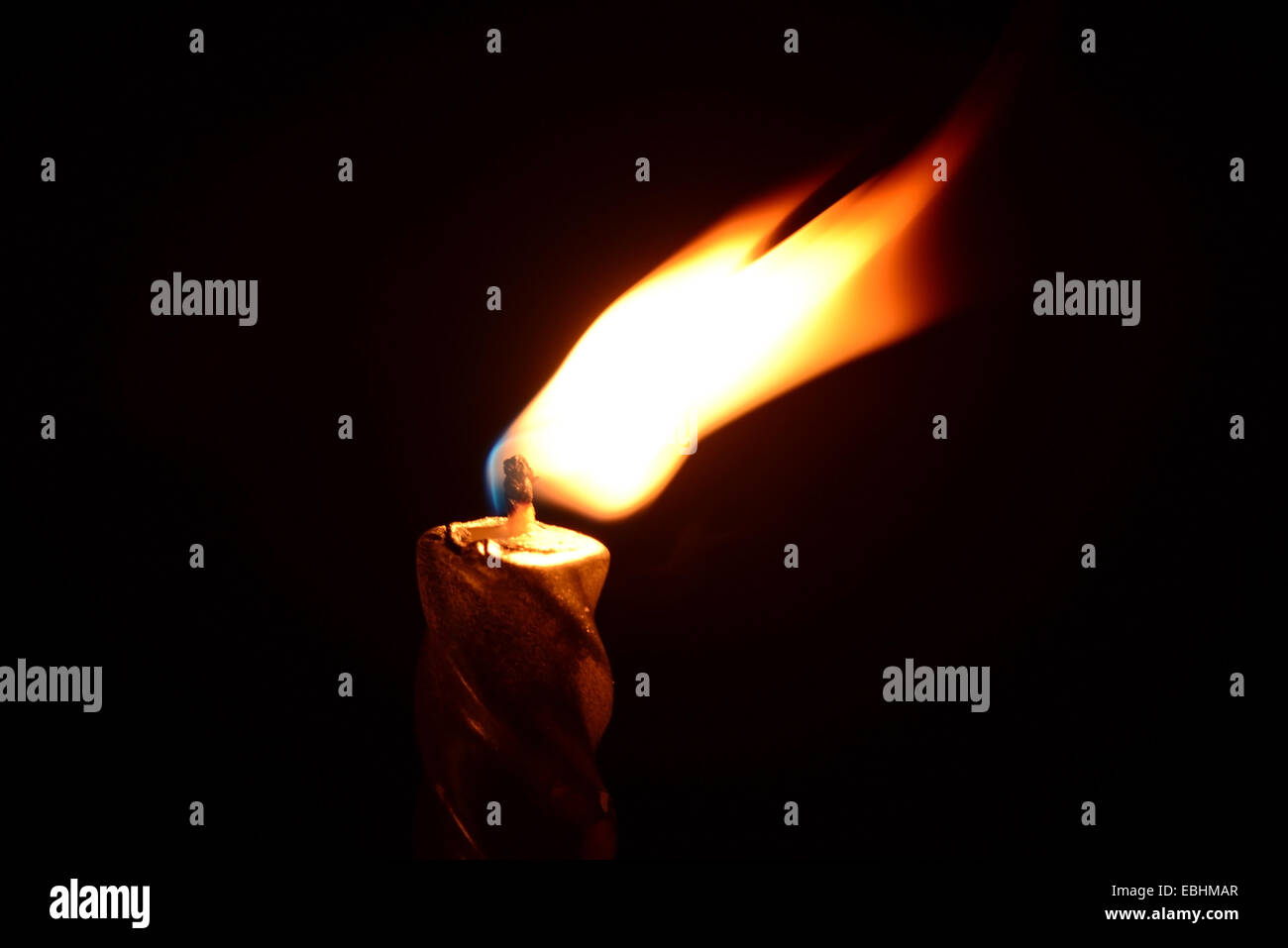 Silver candle burning on a black background Stock Photo - Alamy