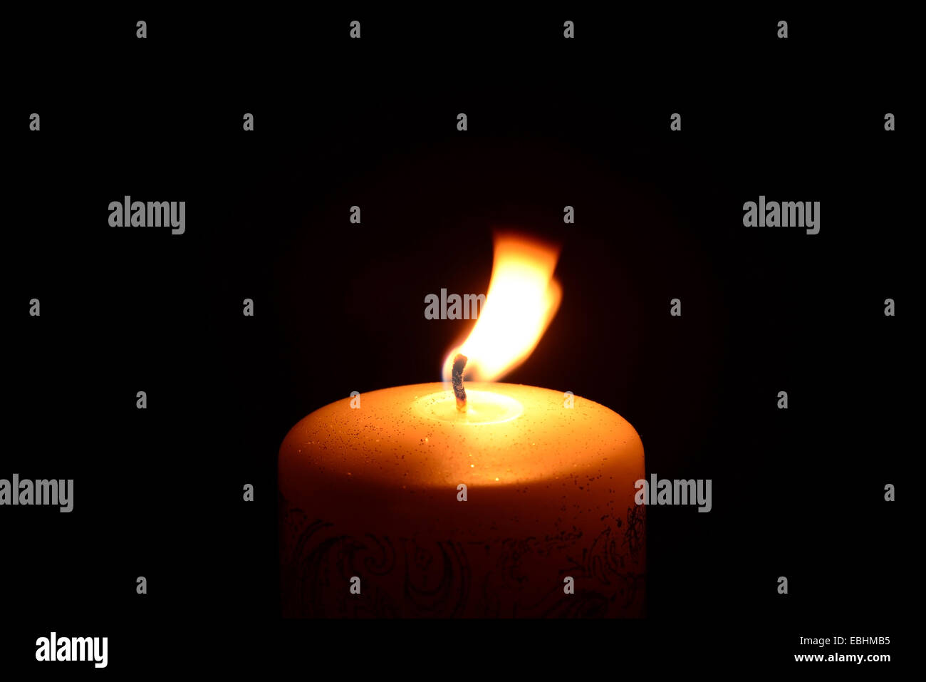 White christmas candle burning on a black background Stock Photo - Alamy