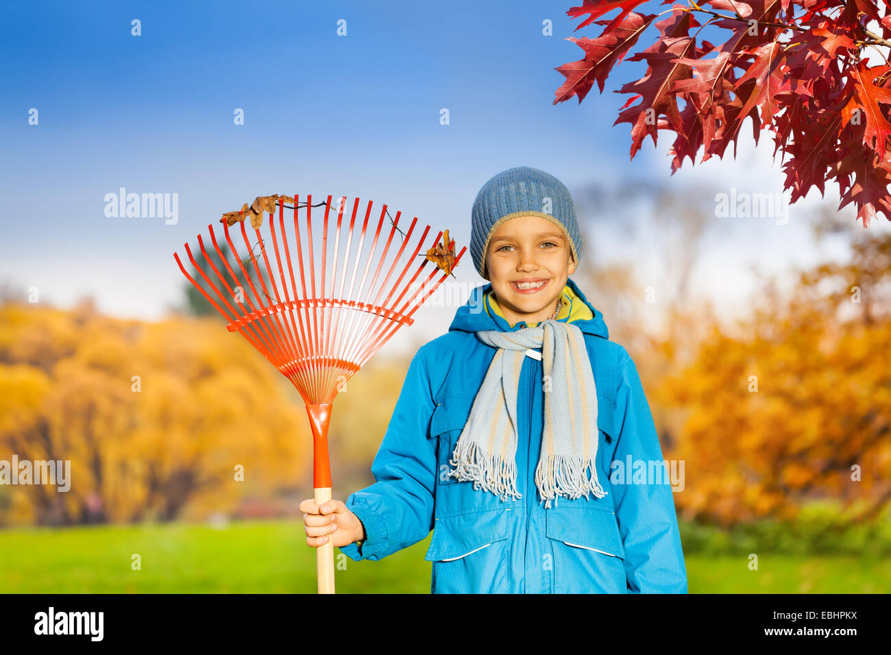Kid With Rake Portrait of small smiling boy with rake in park Stock Photo - Alamy