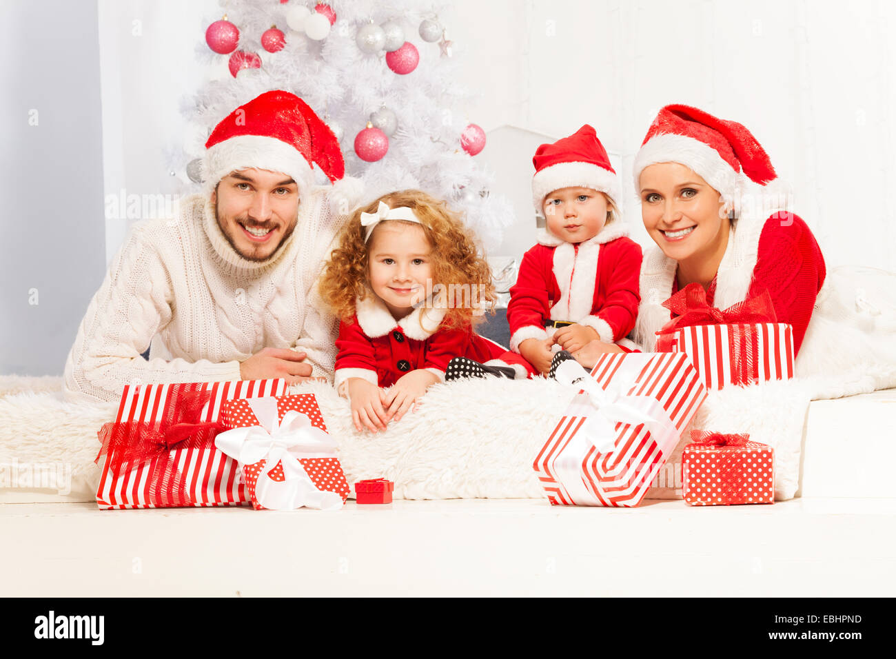 Happy family with presents on New Year eve Stock Photo Alamy