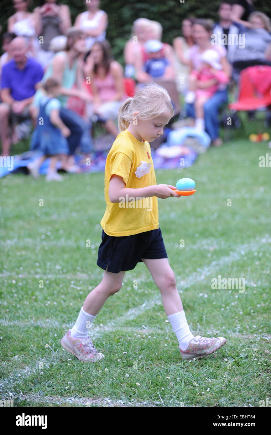 Child running egg and spoon race Stock Photo Alamy