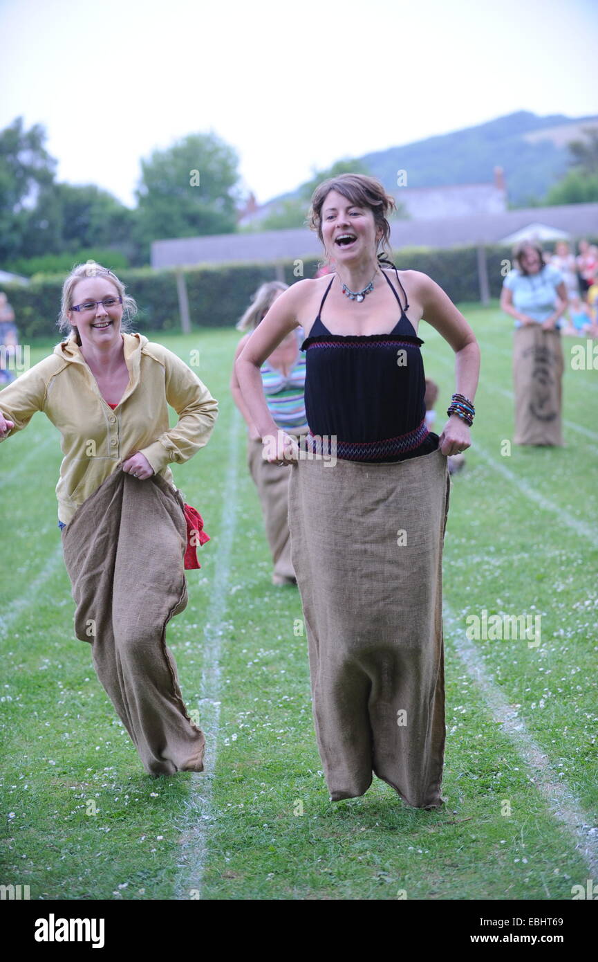 Mums in a sack race at a school sports day Stock Photo