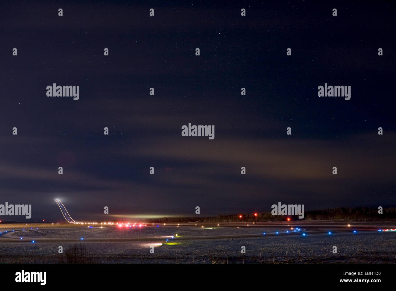 Light trails from an airliner taking off in the night from Skavsta airport, Sweden. Stock Photo