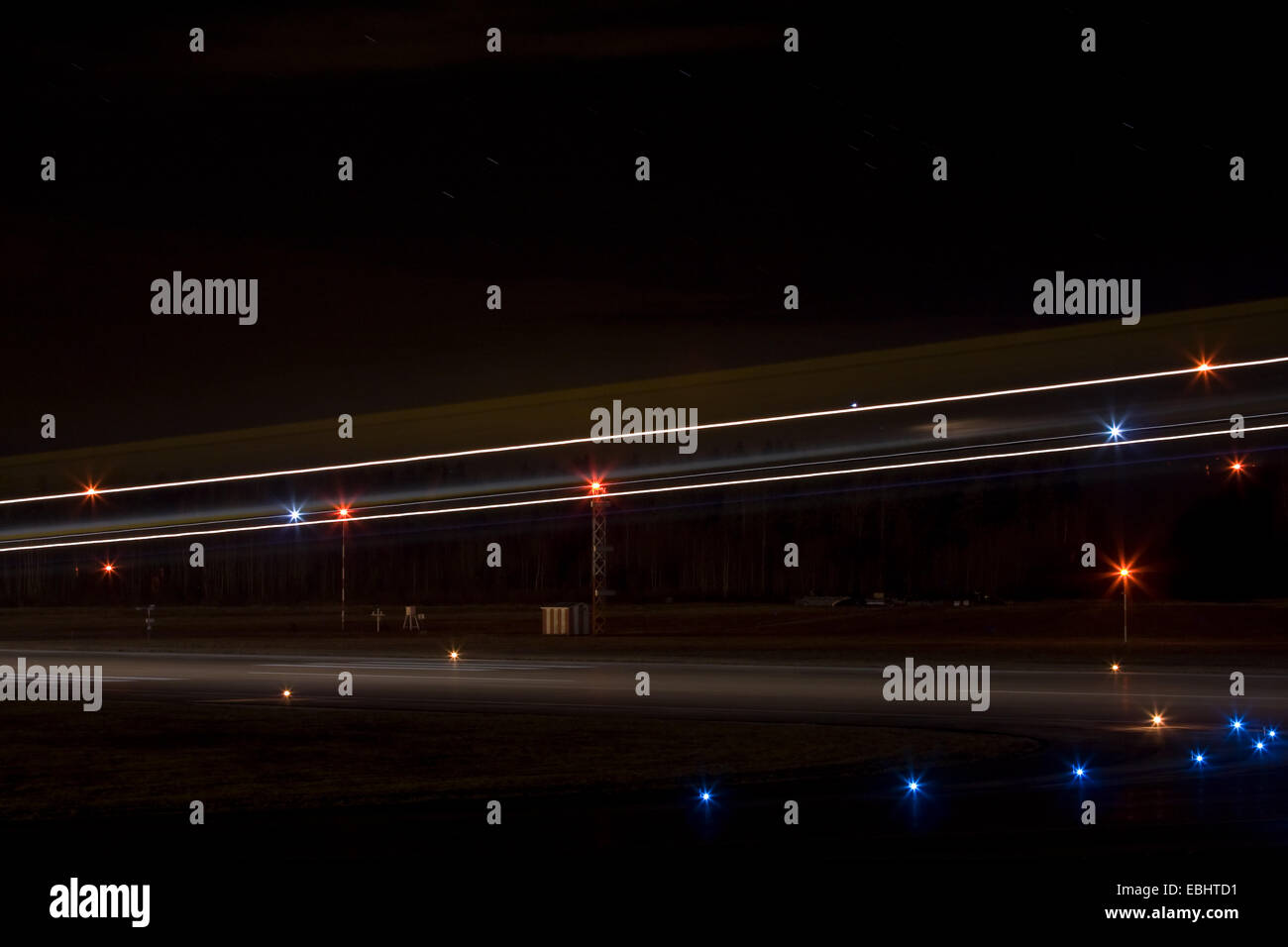 Light trails from an airliner landing the night from Skavsta airport, Sweden. Stock Photo