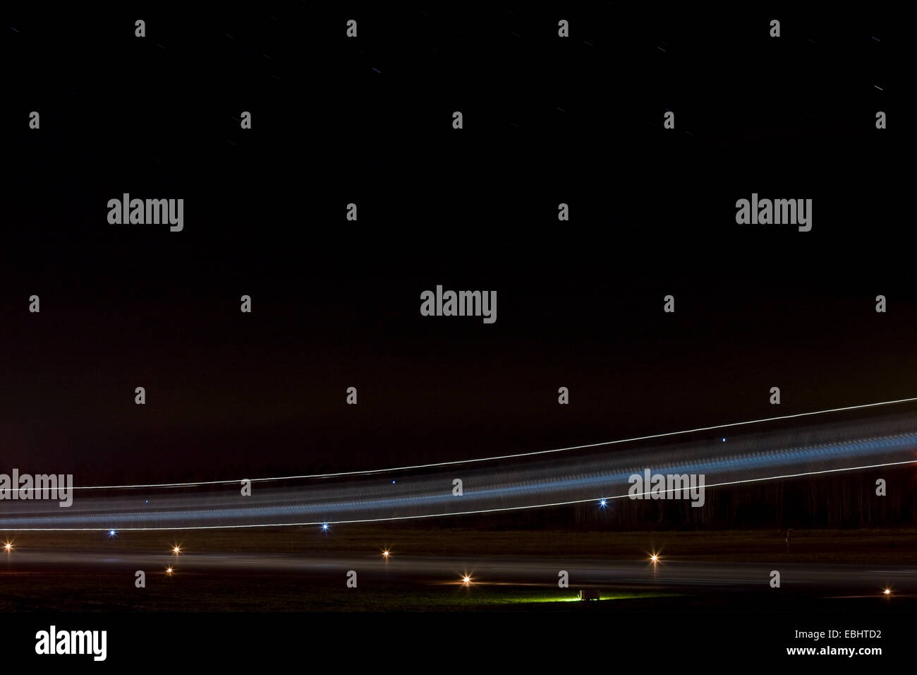 Light trails from an airliner landingin the night from Skavsta airport, Sweden. Stock Photo